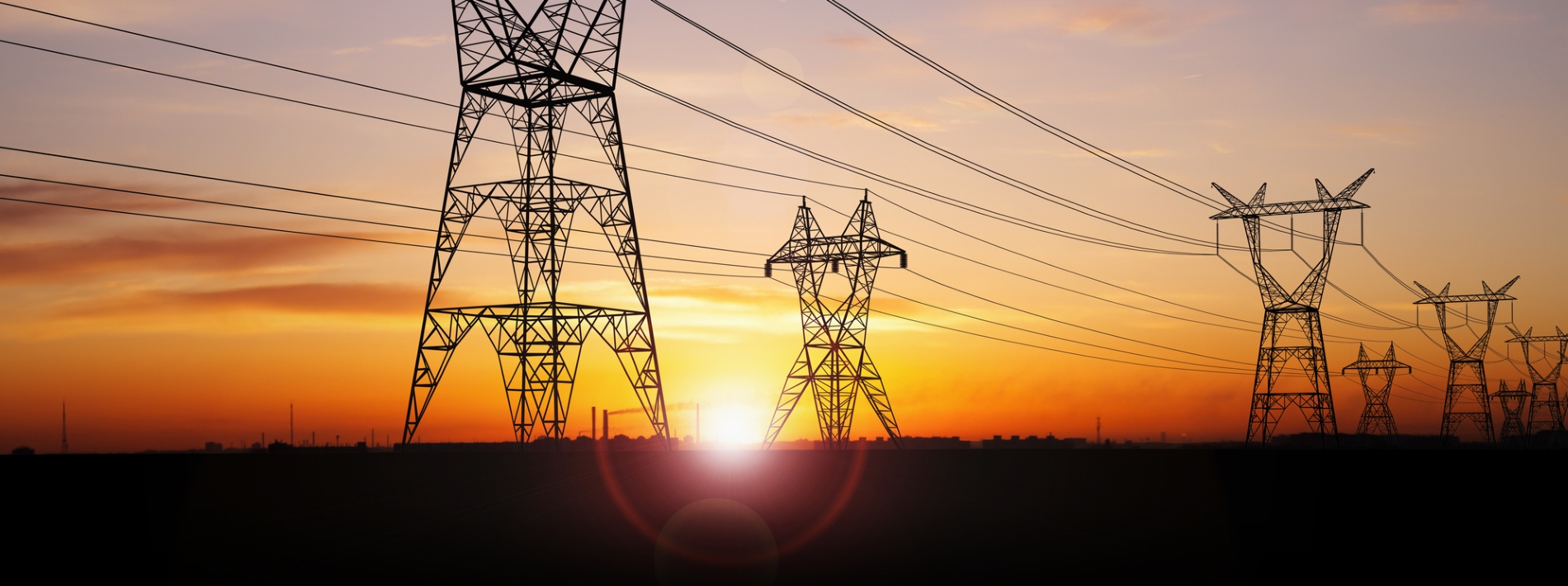 Power pylons with a sunset in the background