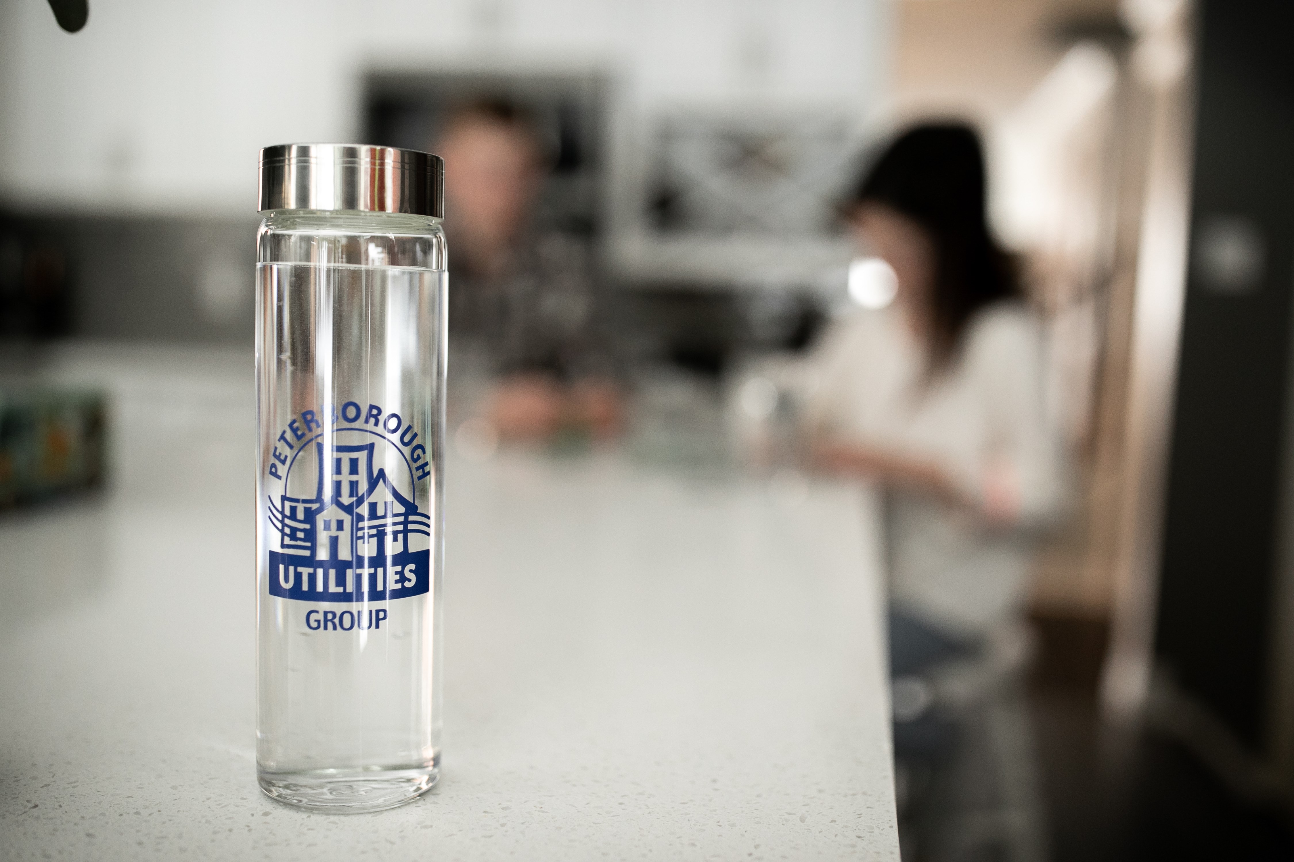 re usable glass bottle of water on a counter