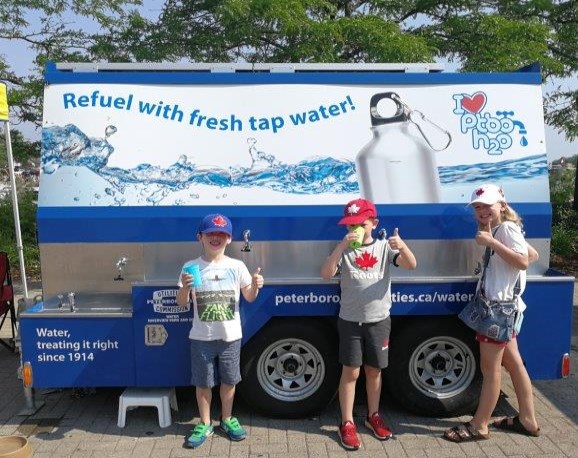 kids enjoying a drink from the mobile water station